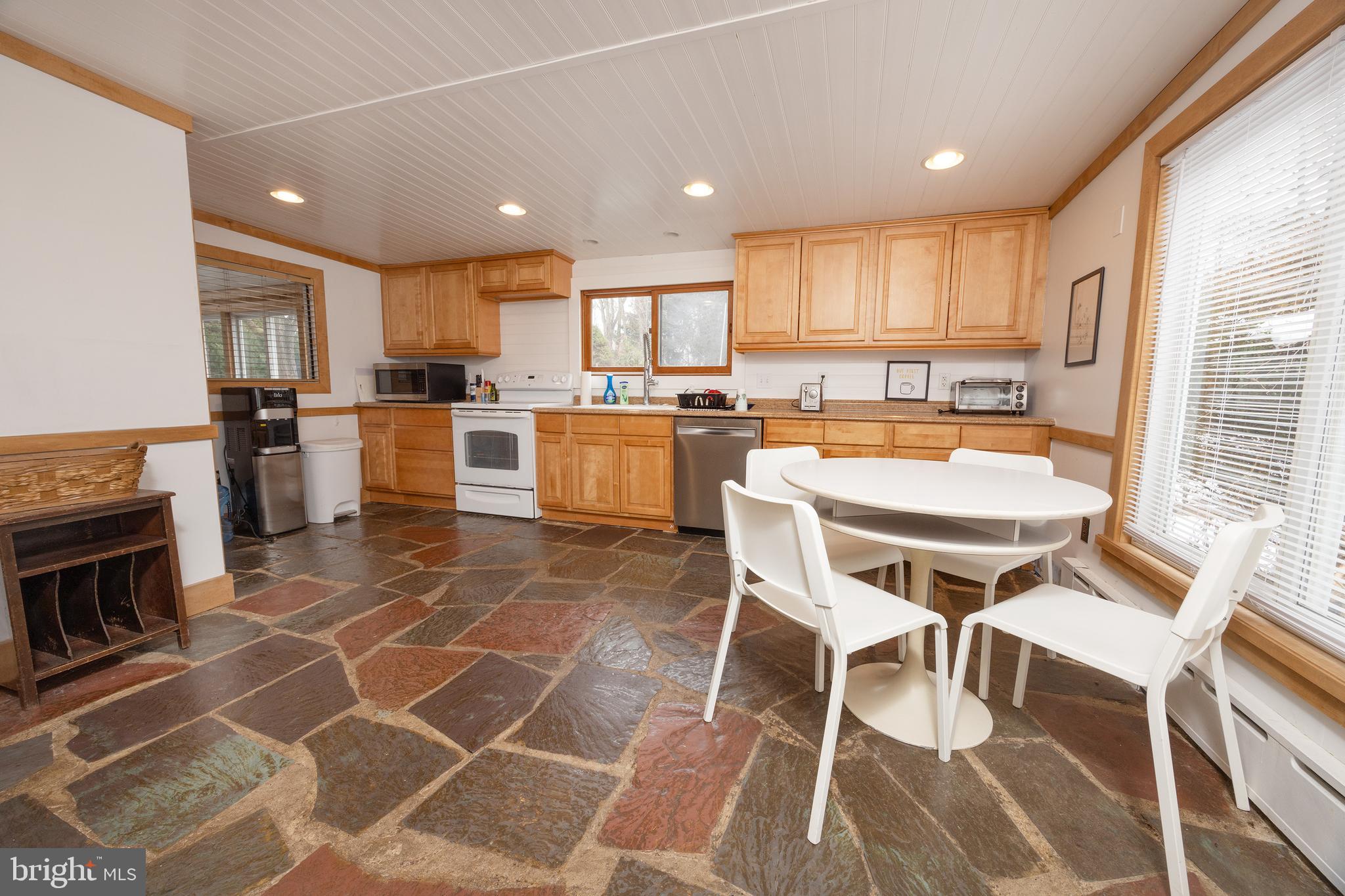 6106 Lower York Road New Hope, PA 18938 - Photo 9 of 20 a kitchen with a dining table chairs and white appliances