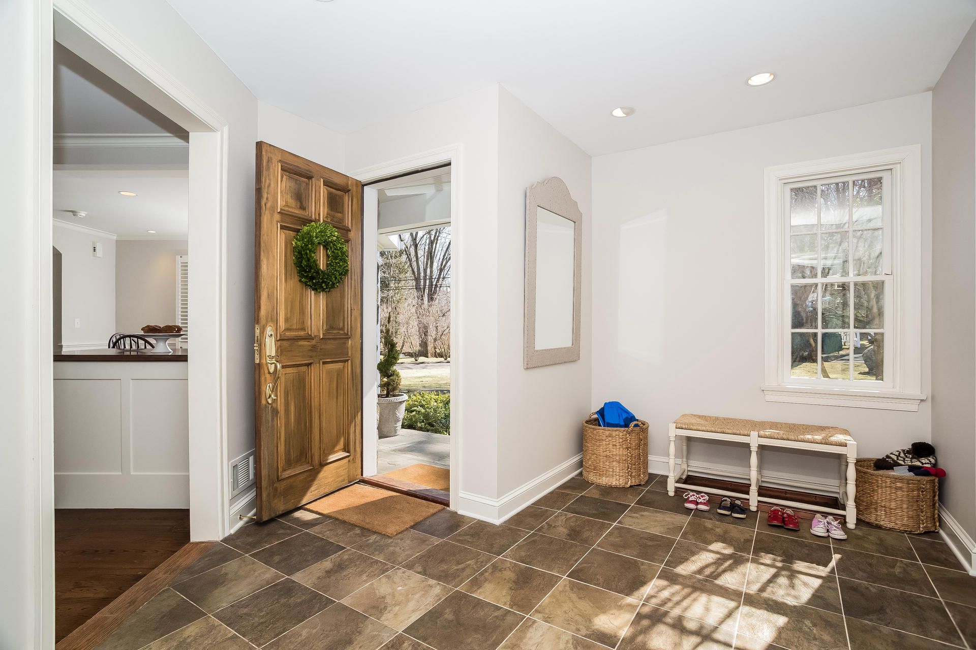 27 Sunset Road Darien, CT 06820 - Photo 2 of 41 a living room with furniture a dining table and a refrigerator