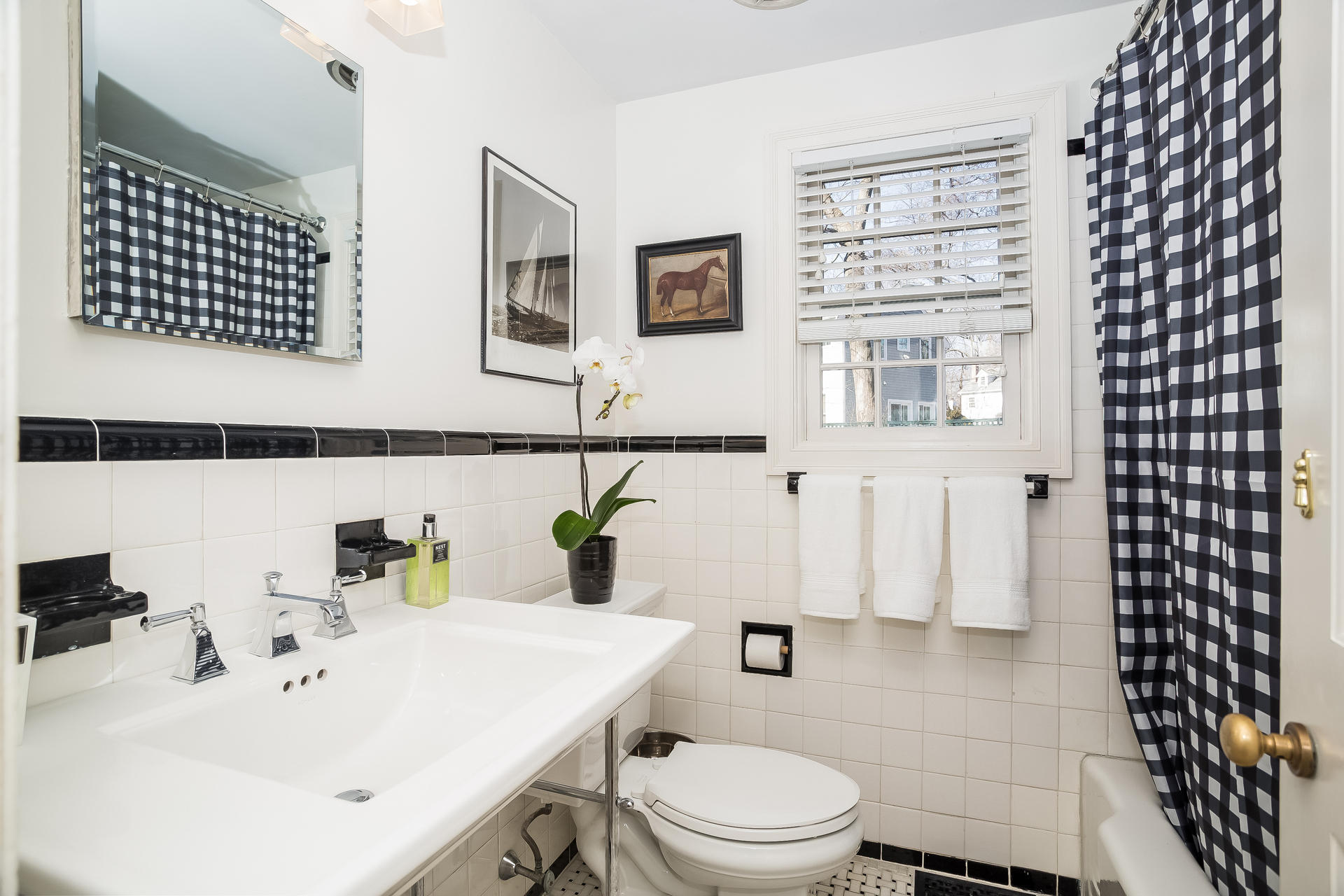 27 Sunset Road Darien, CT 06820 - Photo 17 of 41 a bathroom with a sink a toilet and shower curtain
