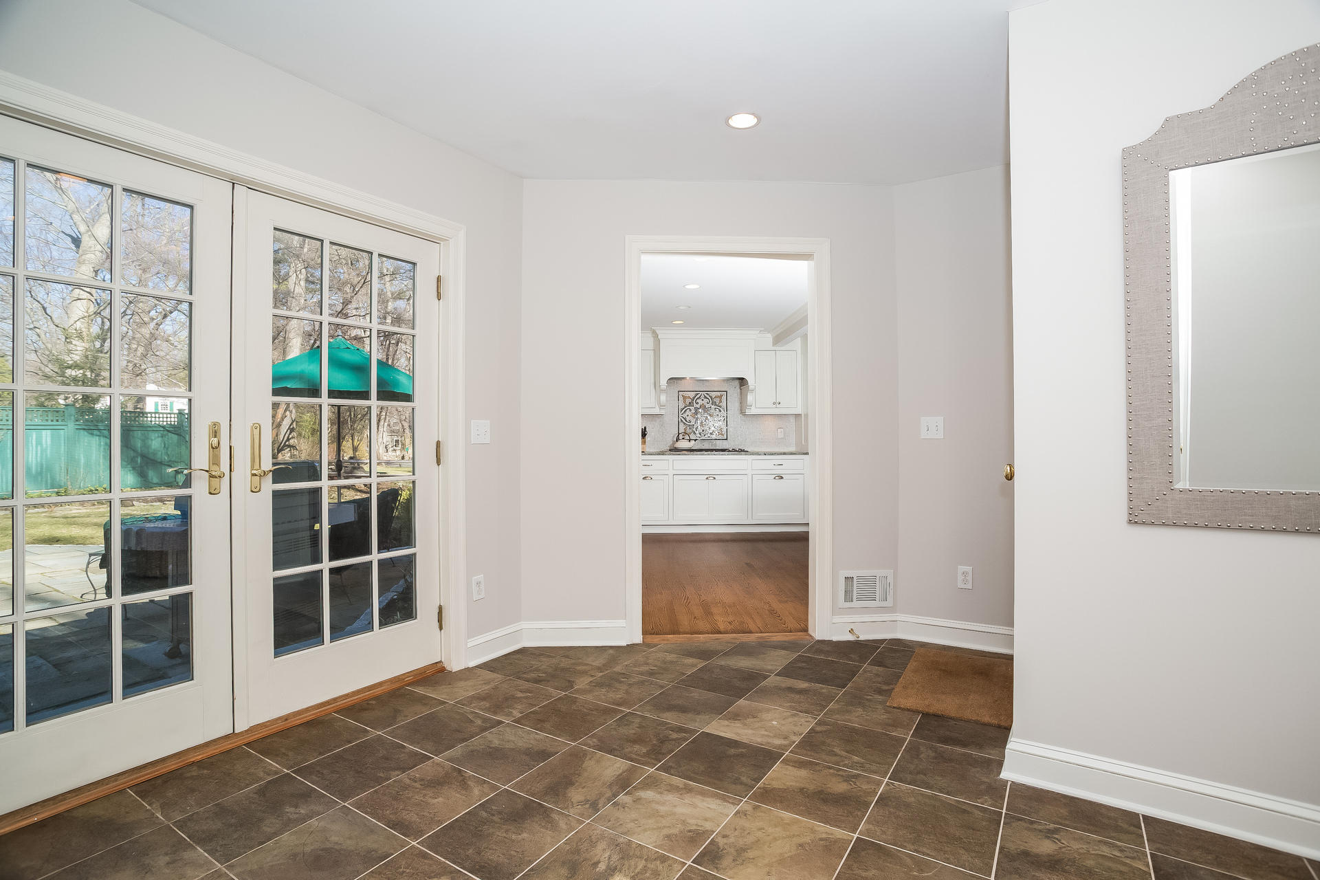 27 Sunset Road Darien, CT 06820 - Photo 3 of 41 a view of an empty room with wooden floor and a window
