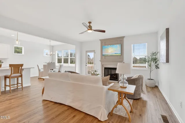 a living room with furniture fireplace and window