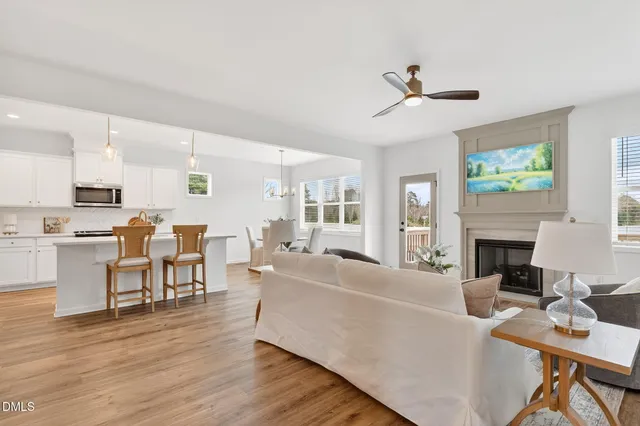 a living room with furniture a fireplace and a flat screen tv
