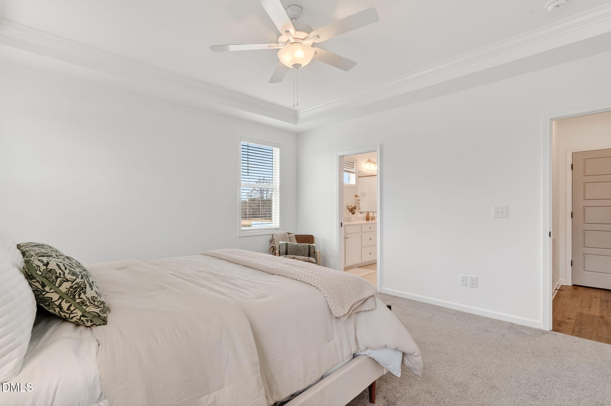 18 North Bream Court Angier, NC 27501 - Photo 17 of 49 a bedroom with a bed and a chandelier