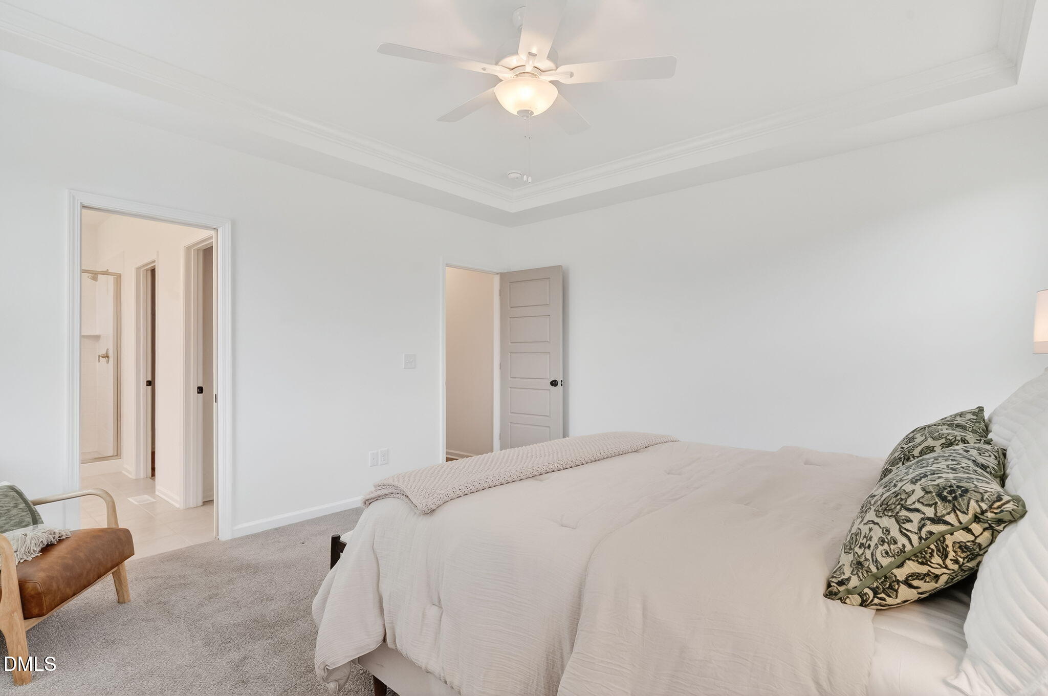 18 North Bream Court Angier, NC 27501 - Photo 18 of 49 a bedroom with a bed and a chandelier