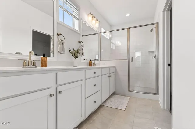 a bathroom with a double vanity sink mirror and