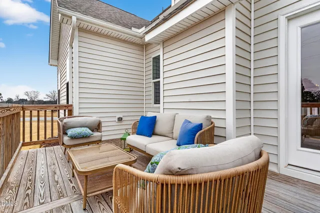 a roof deck with couches and wooden floor
