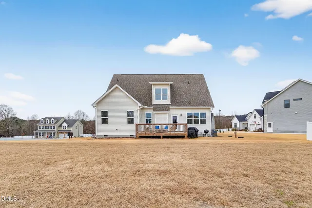 a view of a house with yard and ocean view