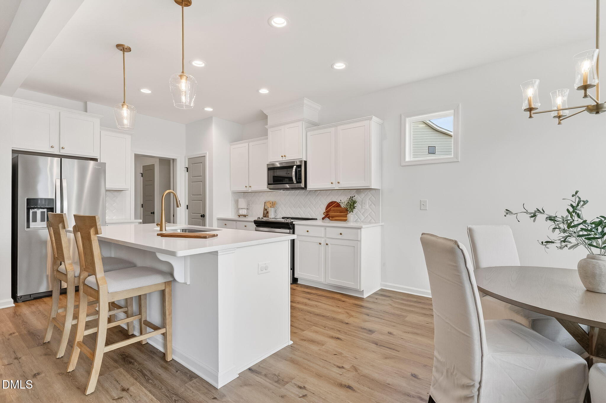 18 North Bream Court Angier, NC 27501 - Photo 7 of 49 a kitchen with white cabinets and stainless steel appliances