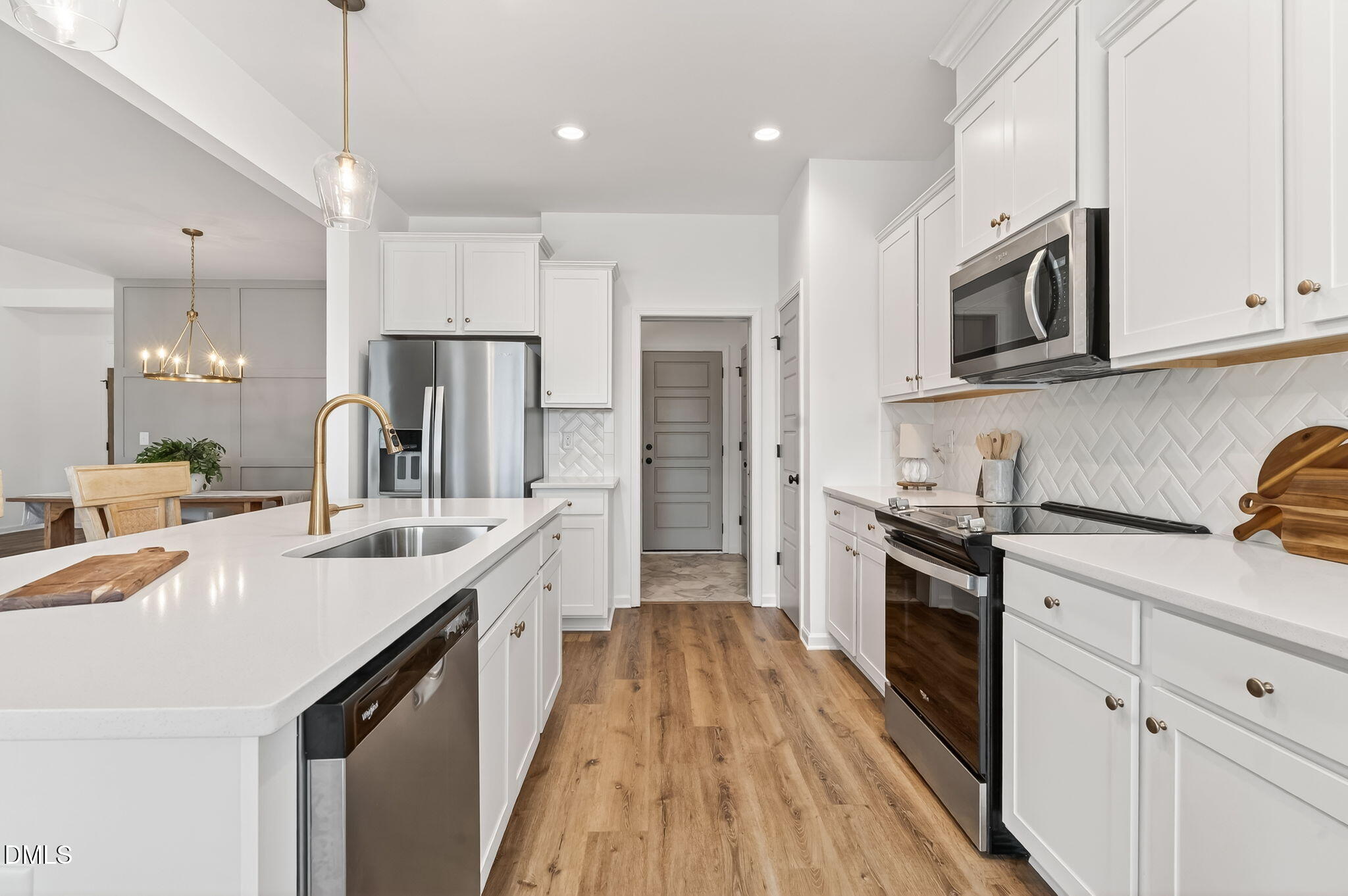 18 North Bream Court Angier, NC 27501 - Photo 8 of 49 a kitchen with stainless steel appliances granite countertop a sink stove and refrigerator