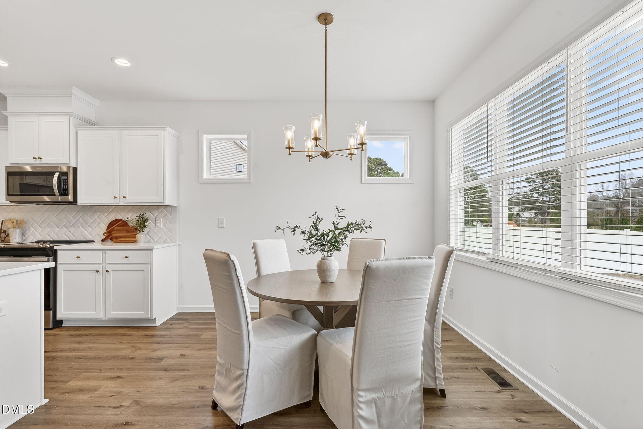 18 North Bream Court Angier, NC 27501 - Photo 10 of 49 a view of a dining room with furniture a chandelier and wooden floor