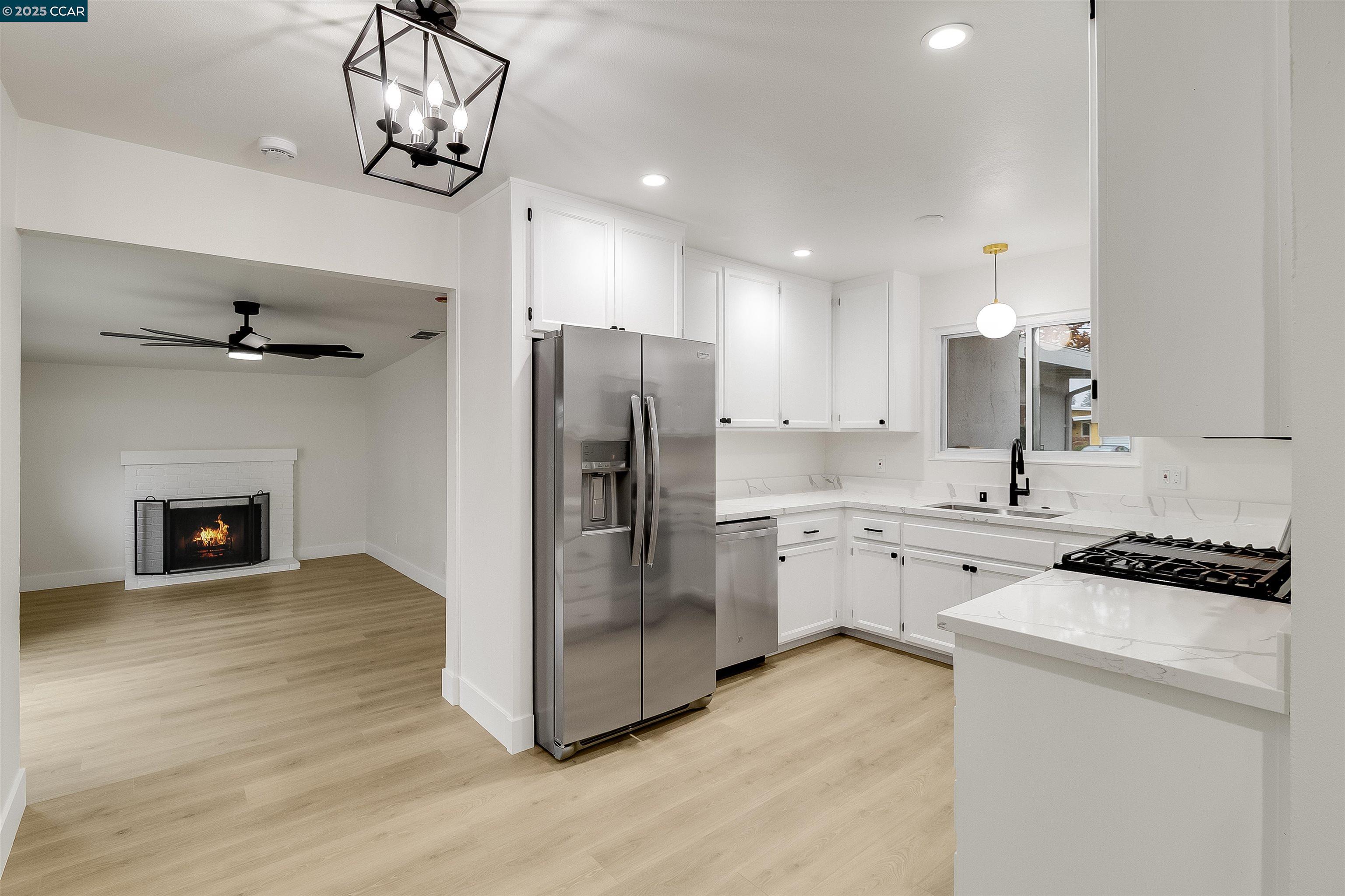 1863 San Clemente Street Fairfield, CA 94533 - Photo 12 of 29 a kitchen with a refrigerator and a chandelier