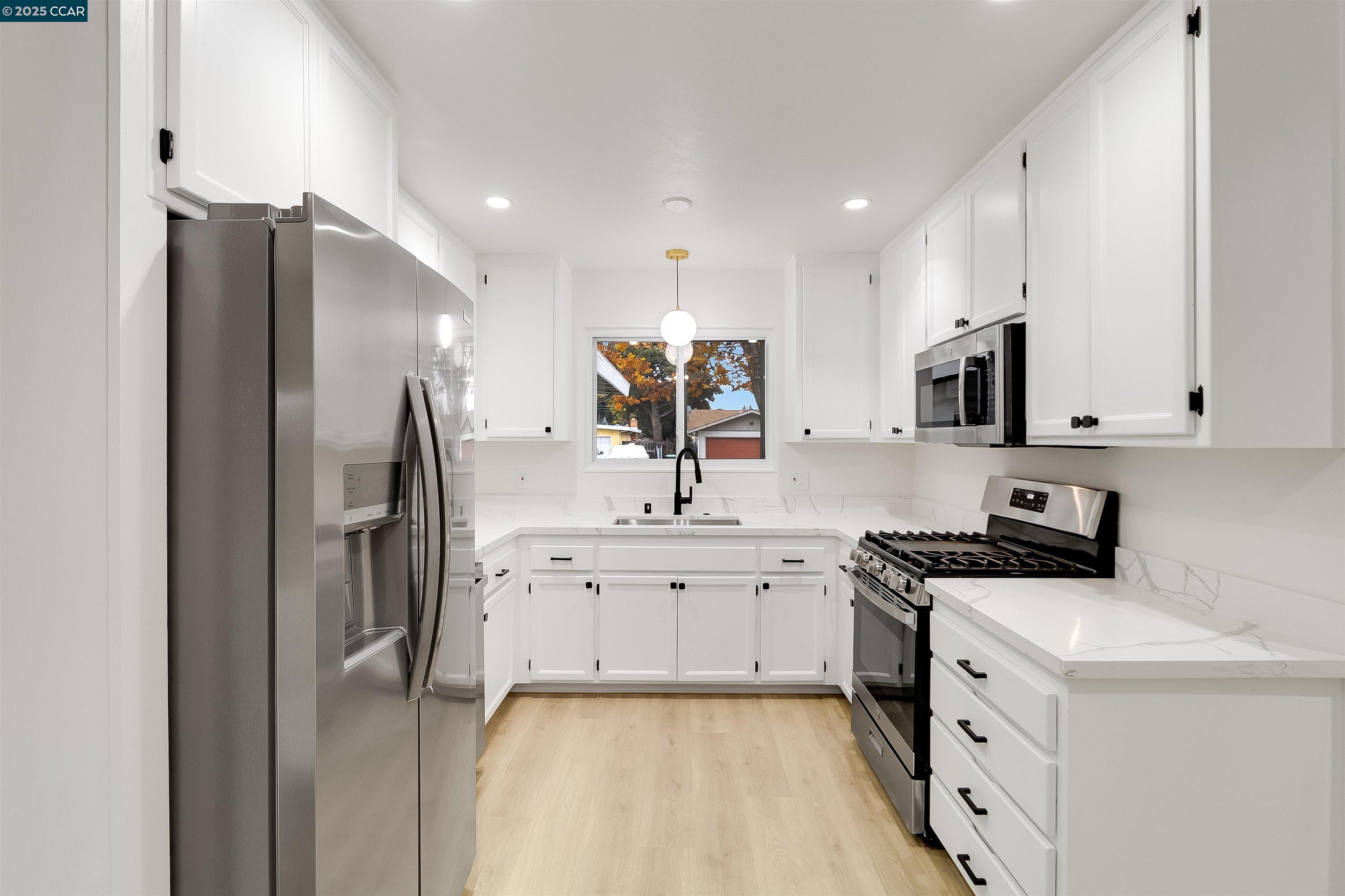 1863 San Clemente Street Fairfield, CA 94533 - Photo 13 of 29 a kitchen with white cabinets and stainless steel appliances
