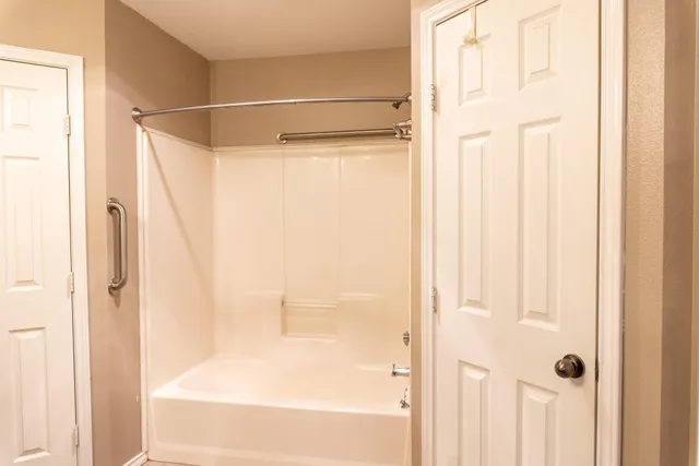 a bathroom with a shower and a tub