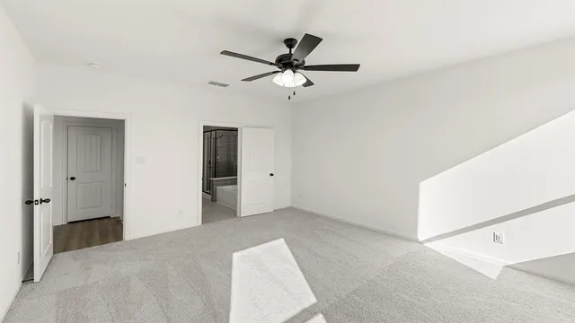 a view of empty room with ceiling fan
