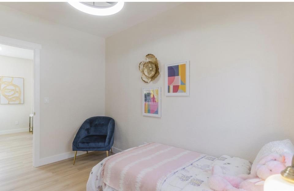 735 Locust Street San Jose, CA 95110 - Photo 18 of 21 a bedroom with a bed and a table in it