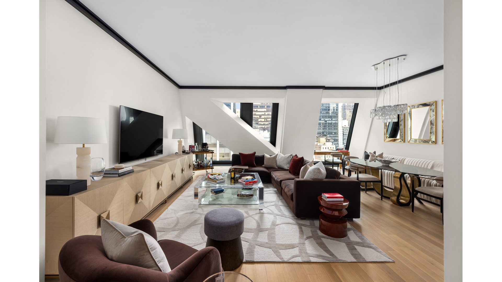 53 West 53rd Street, Unit 18B Manhattan, NY 10019 - Photo 1 of 17 a living room with furniture and a flat screen tv