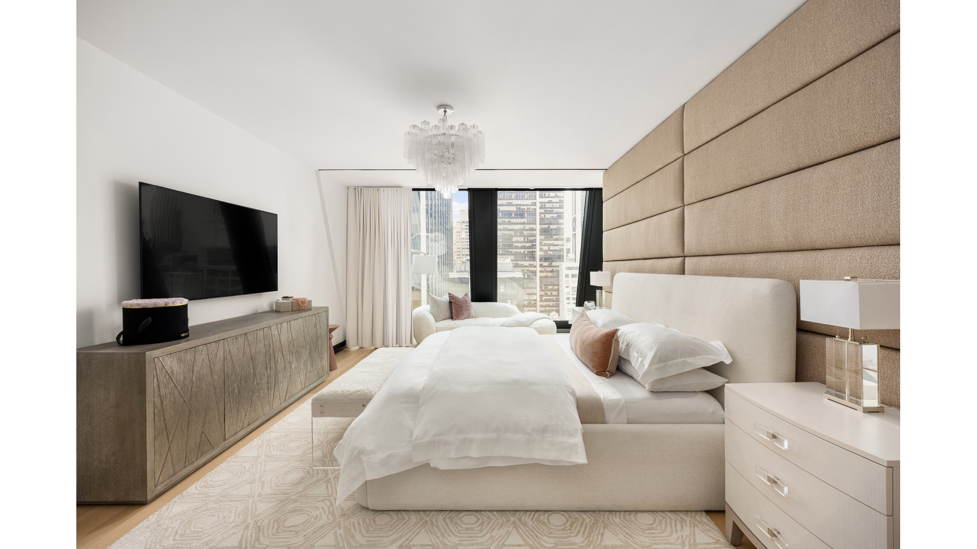 53 West 53rd Street, Unit 18B Manhattan, NY 10019 - Photo 10 of 17 a bedroom with a bed and a flat screen tv