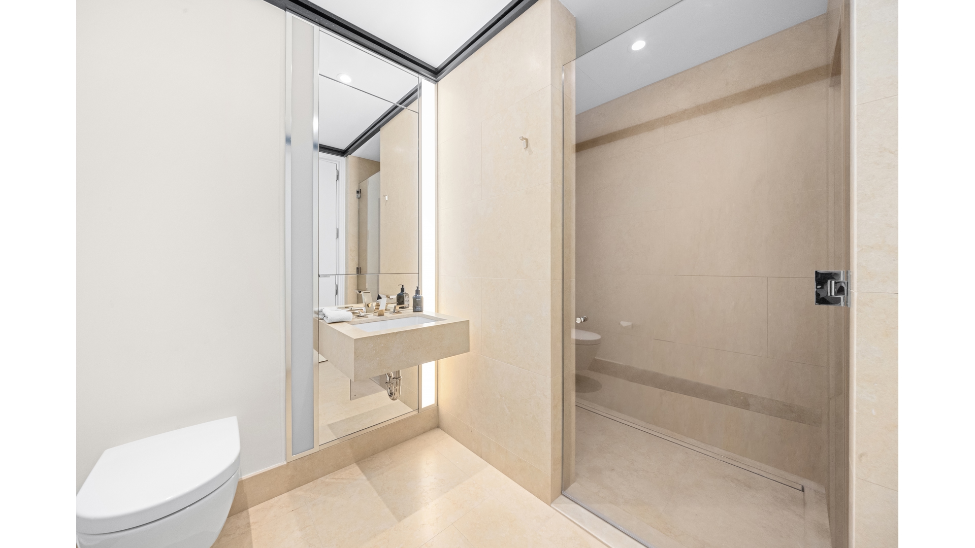 53 West 53rd Street, Unit 18B Manhattan, NY 10019 - Photo 15 of 17 a bathroom with a toilet a sink and shower