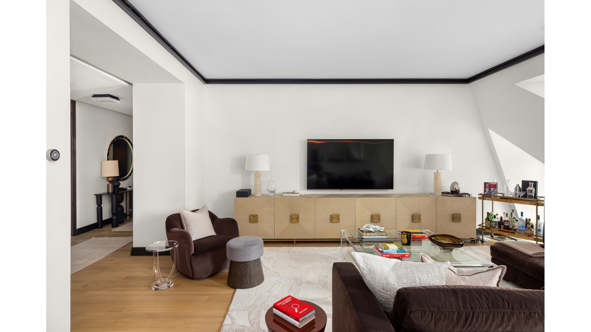 53 West 53rd Street, Unit 18B Manhattan, NY 10019 - Photo 3 of 17 a living room with furniture and a flat screen tv