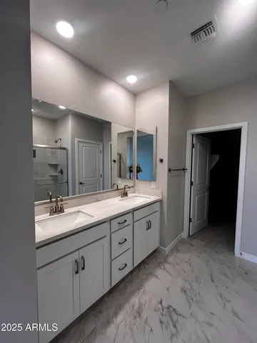 a spacious bathroom with a granite countertop sink mirror and double