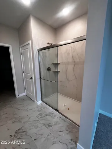 a bathroom with a glass shower door