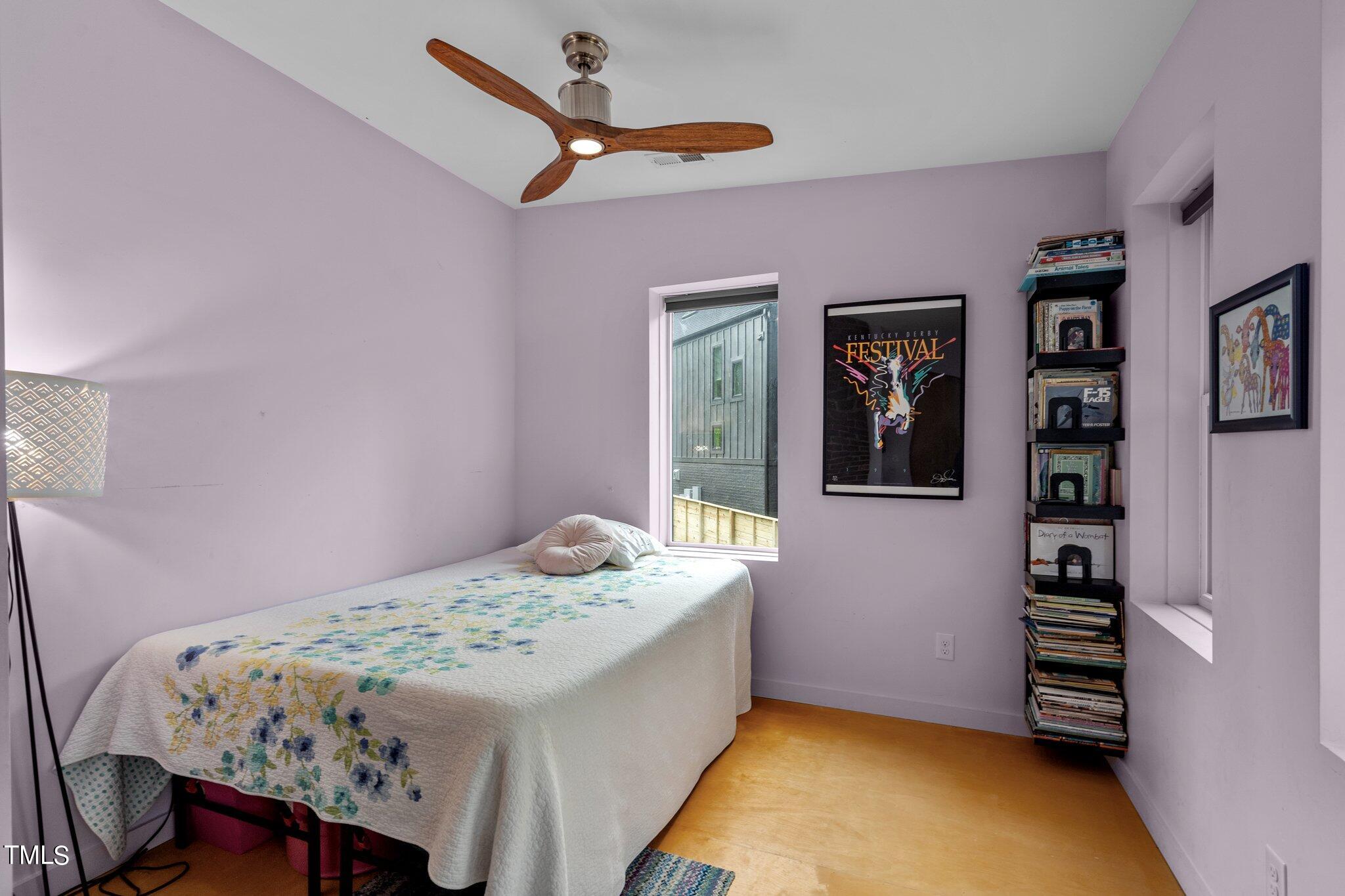 1330 Mordecai Drive Raleigh, NC 27604 - Photo 24 of 56 a bedroom with a bed and a wall painting