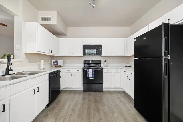 a kitchen with a refrigerator stove and sink