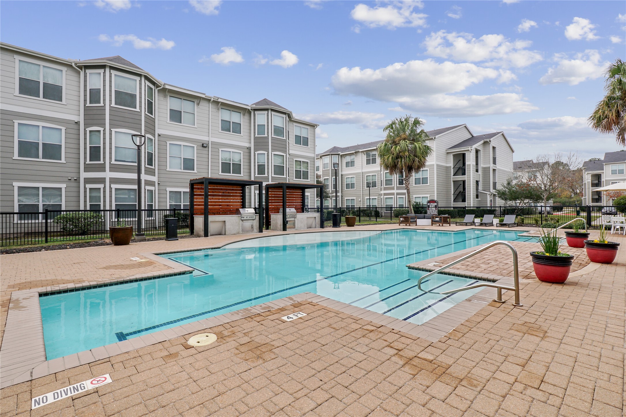 9494 Humble Westfield Road, Unit 3022 Humble, TX 77338 - Photo 2 of 22 a view of a swimming pool with a lounge chairs