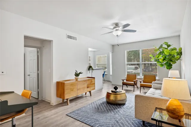 a living room with furniture and a potted plant