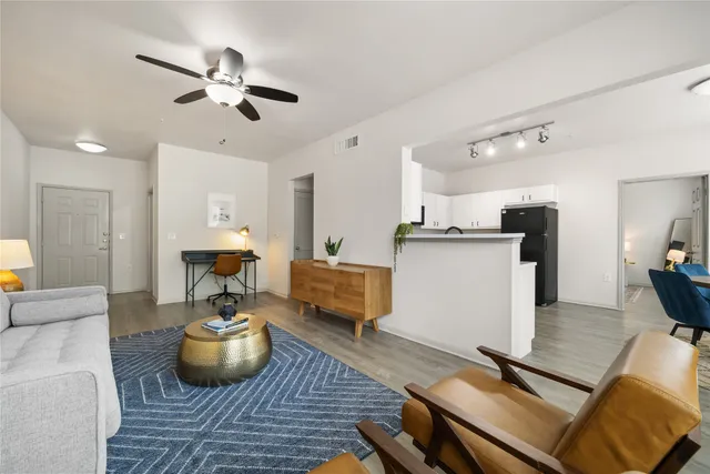 a living room with furniture and wooden floor