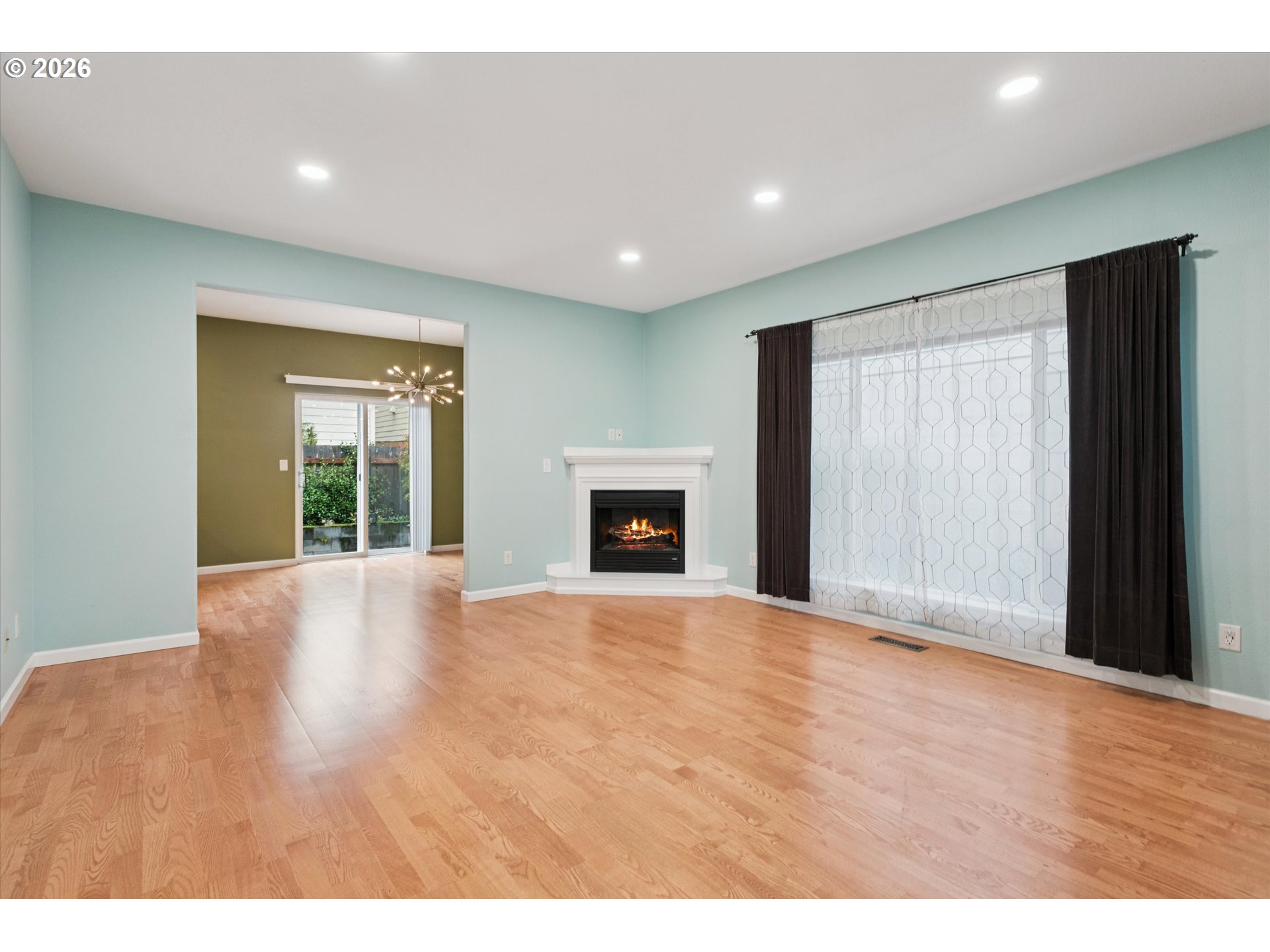 18232 Southwest Orlov Court Beaverton, OR 97078 - Photo 3 of 17 a view of an empty room with wooden floor and a window