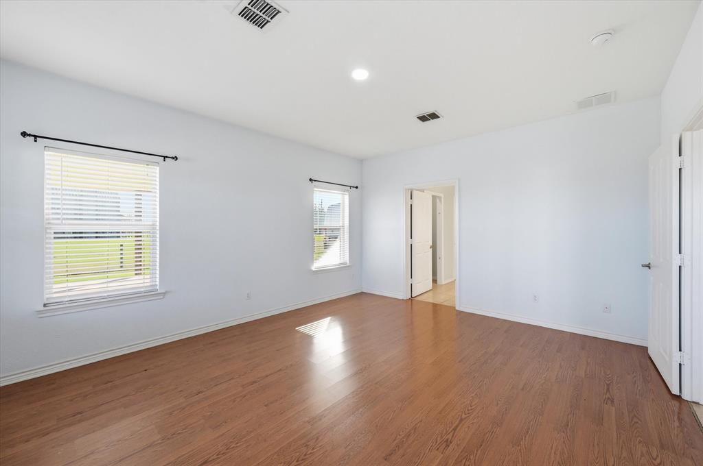 1616 Nash-Howard Road Waxahachie, TX 75165 - Photo 25 of 36 an empty room with wooden floor and windows