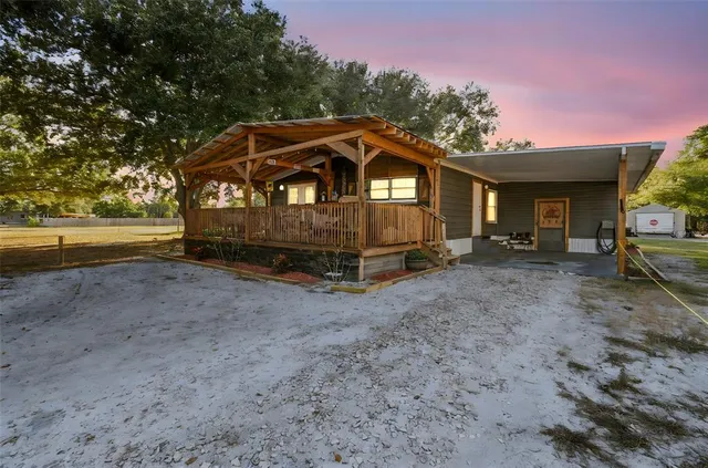 a view of a house with a yard and sitting area