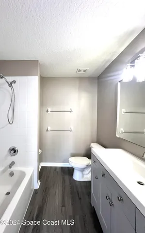 a bathroom with a sink a toilet and bathtub