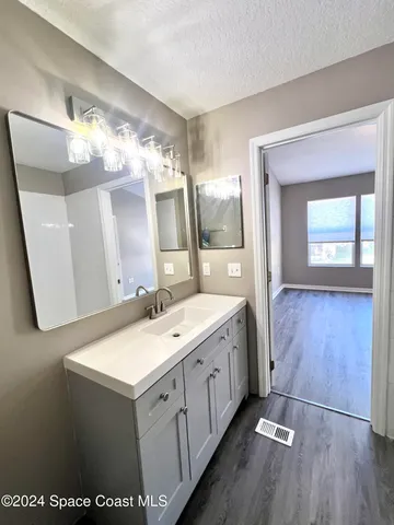 a spacious bathroom with a double vanity sink and a mirror