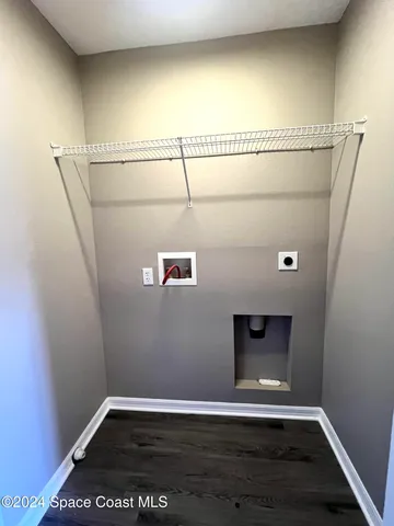 a room with a wooden floor and a fireplace