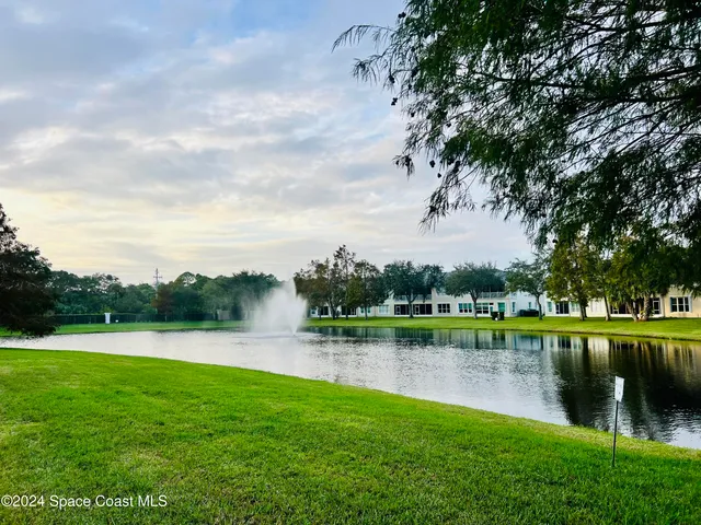 a view of a lake with houses in the back