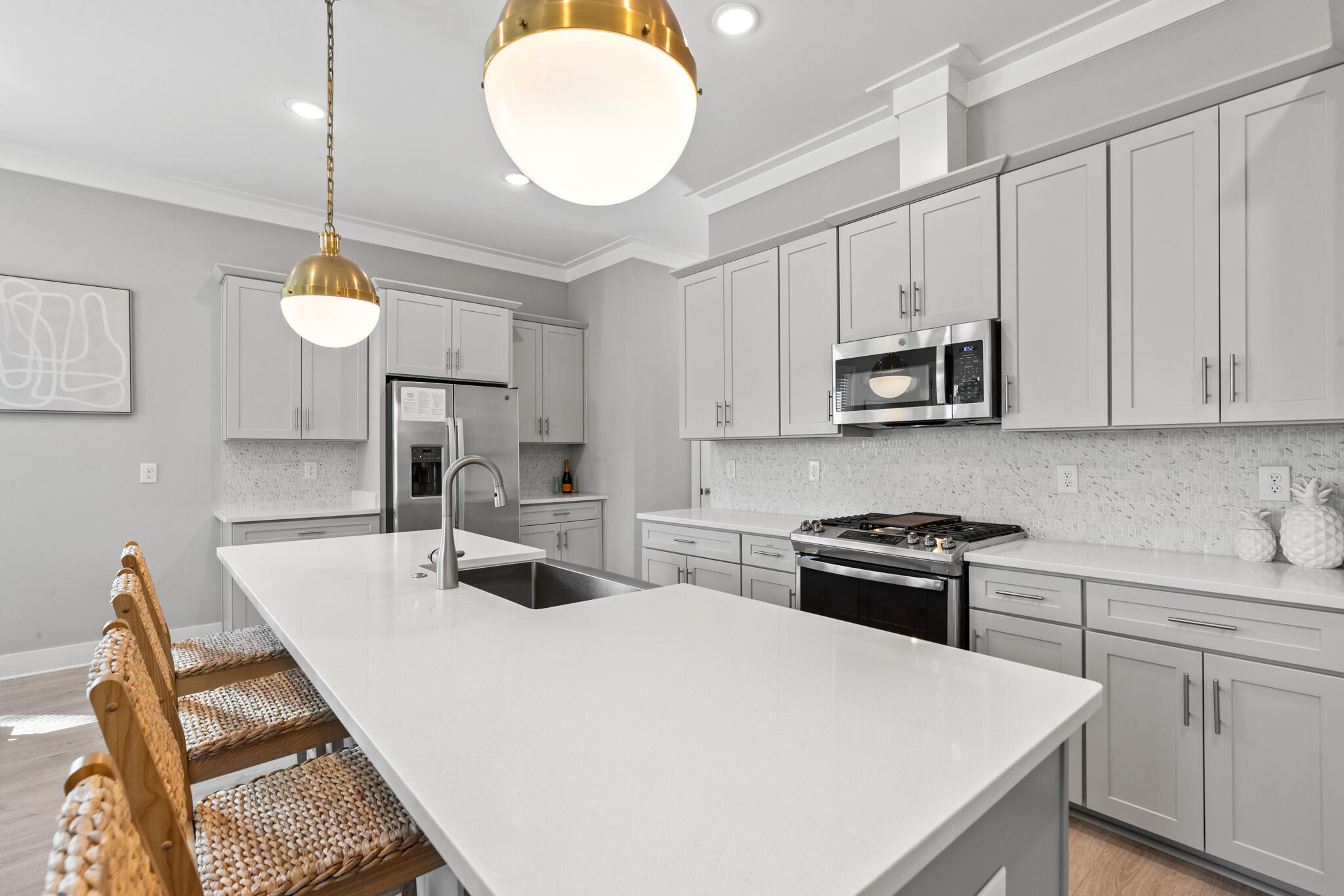 151 West Willow Mist Road Inlet Beach, FL 32461 - Photo 20 of 70 a kitchen with kitchen island a stove a sink a dining table and chairs with wooden floor