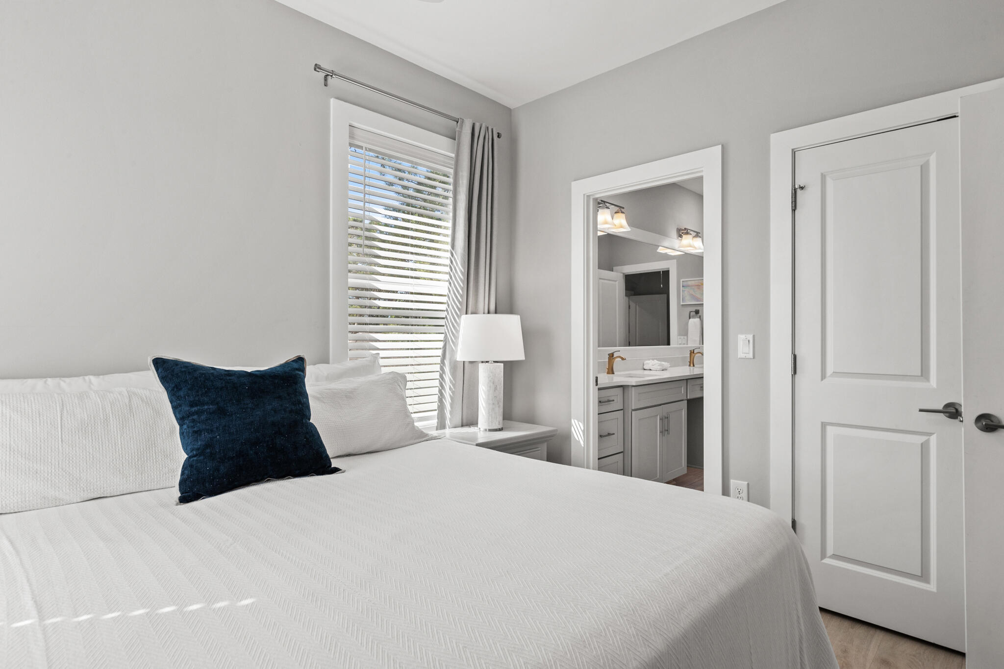 151 West Willow Mist Road Inlet Beach, FL 32461 - Photo 29 of 70 a bedroom with a large bed and wooden floor