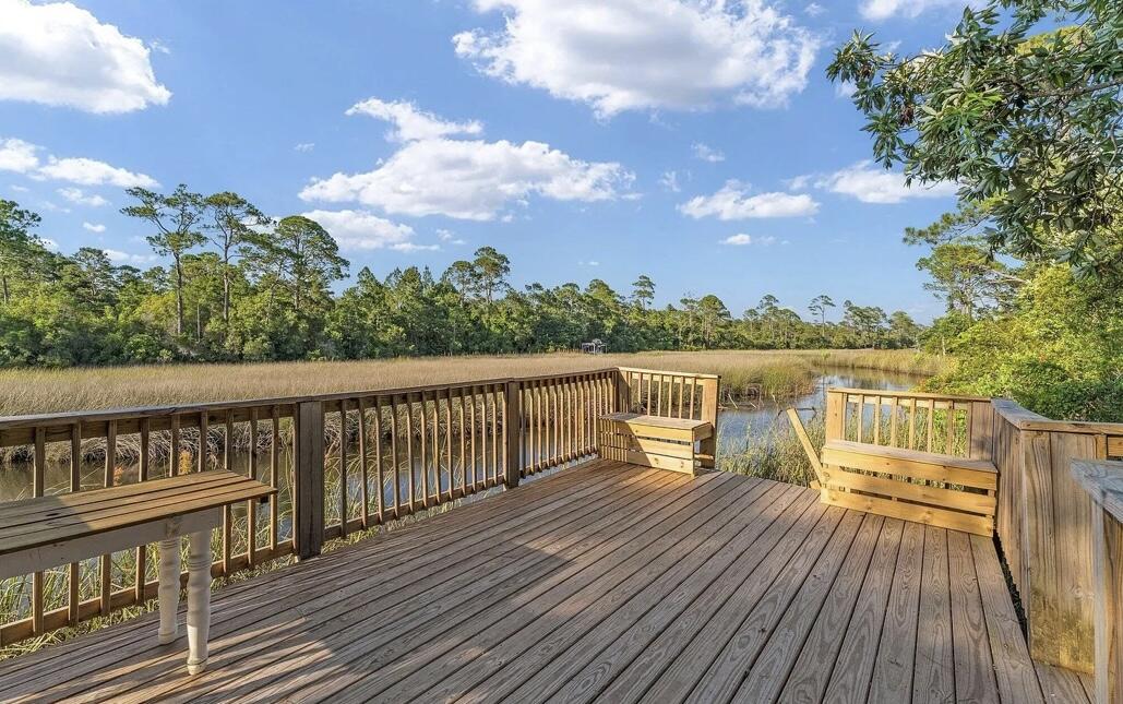 151 West Willow Mist Road Inlet Beach, FL 32461 - Photo 53 of 70 a view of a balcony with wooden chairs and floor to ceiling window