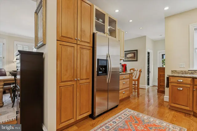 a kitchen with stainless steel appliances granite countertop a refrigerator and a sink