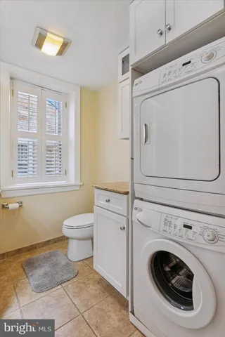 a living room with furniture and floor to ceiling window