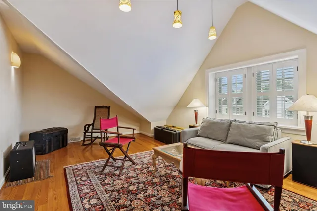 a living room with furniture and a book shelf