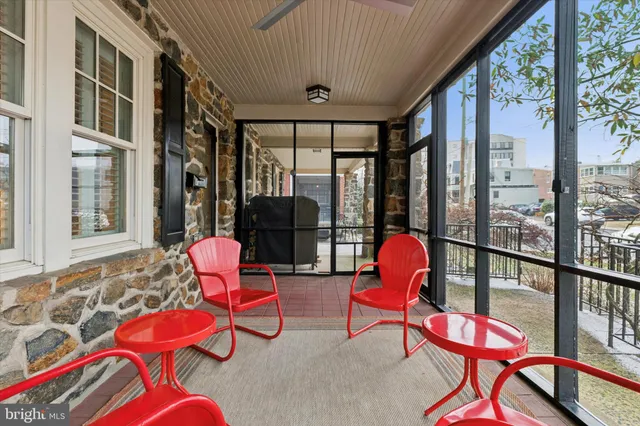a living room with furniture and floor to ceiling windows