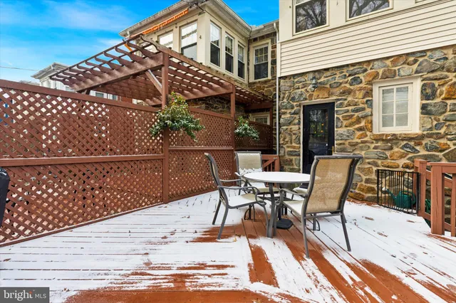 an outdoor sitting area with furniture and umbrella