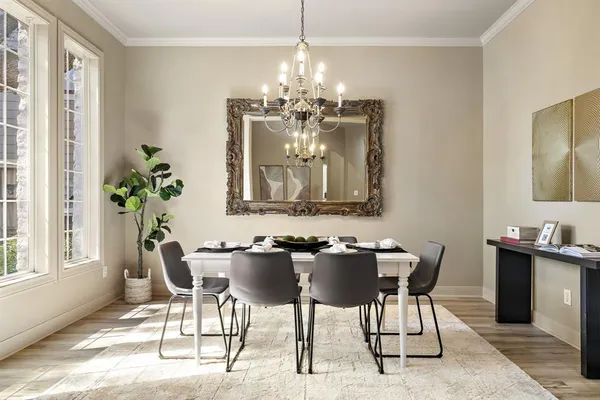 a view of a dining room with furniture and chandelier