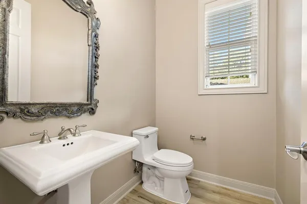 a bathroom with a sink a toilet and mirror