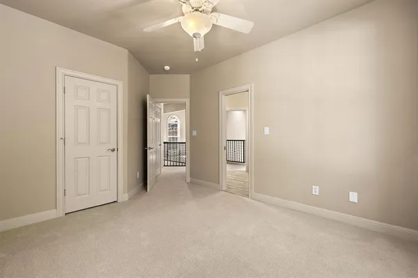 an empty room with fan and entrance