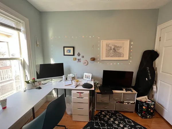 a view of a workspace with furniture and a flat screen tv