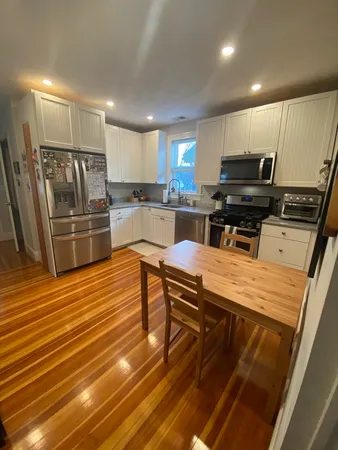 a kitchen with microwave a stove and cabinets